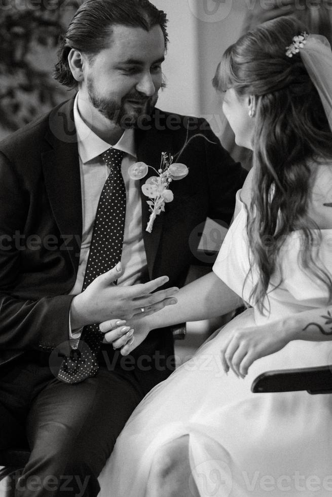 young couple bride and groom in a white dress photo