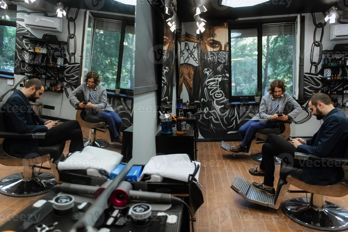 bearded man cutting his beard in the barbershop photo