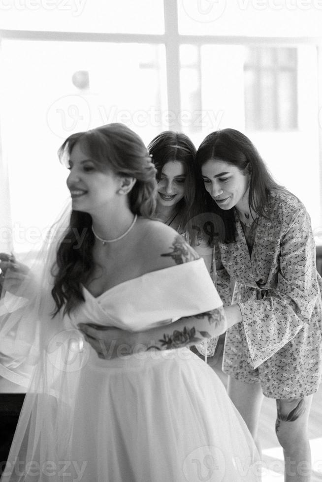 preparations for the bride with the dressing of the wedding dress photo