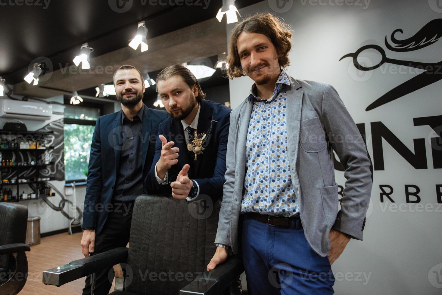 retrato de un novio masculino con traje azul en la barbería de la mañana foto