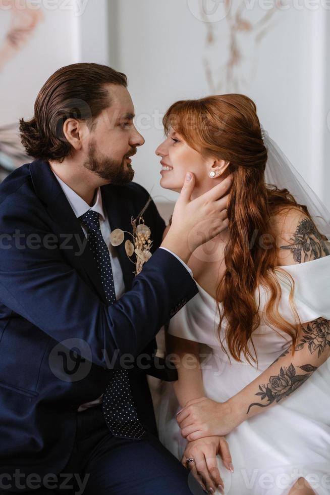 young couple bride and groom in a white dress photo