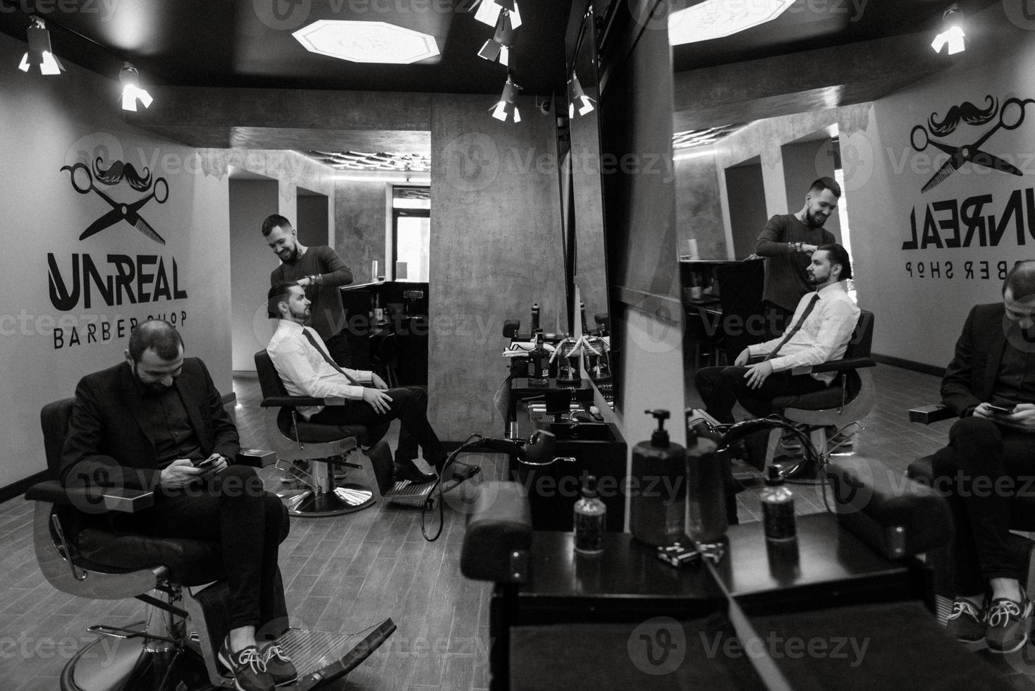 bearded man cutting his beard in the barbershop photo