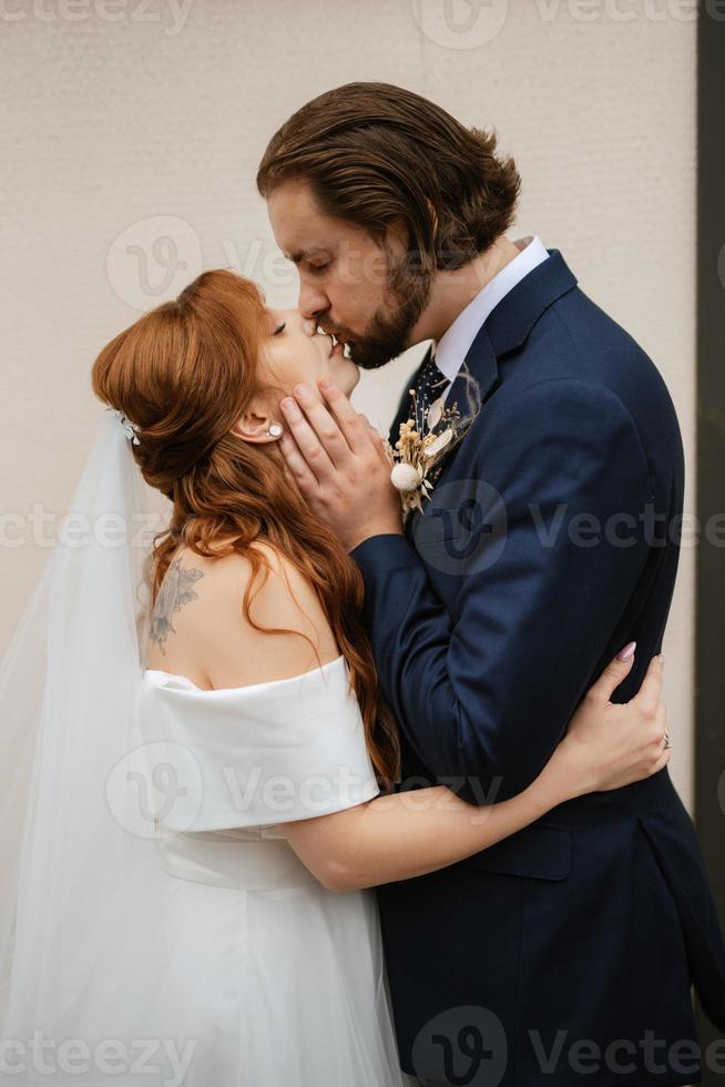 young couple bride and groom in a white dress photo