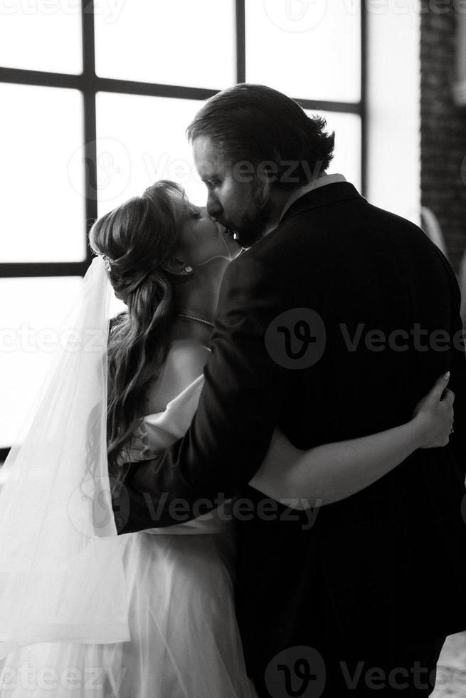 young couple bride and groom in a white dress photo