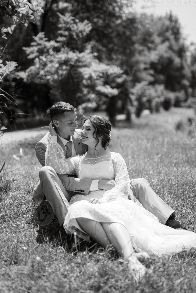 bride in a light wedding dress to the groom in a blue suit photo