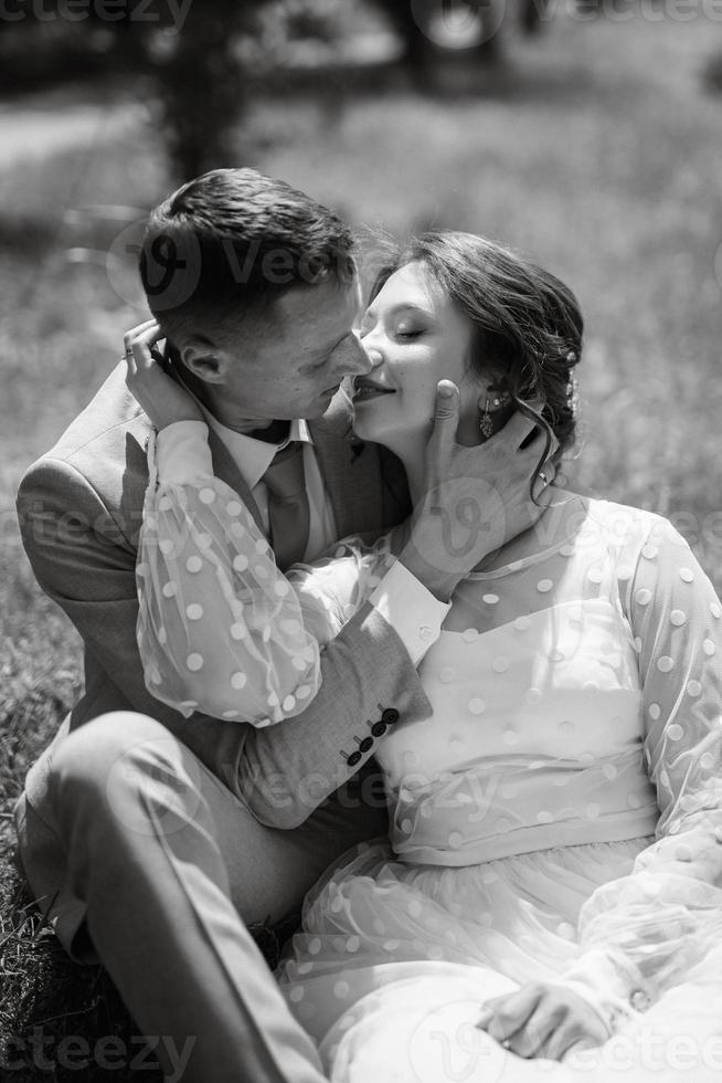 bride in a light wedding dress to the groom in a blue suit photo