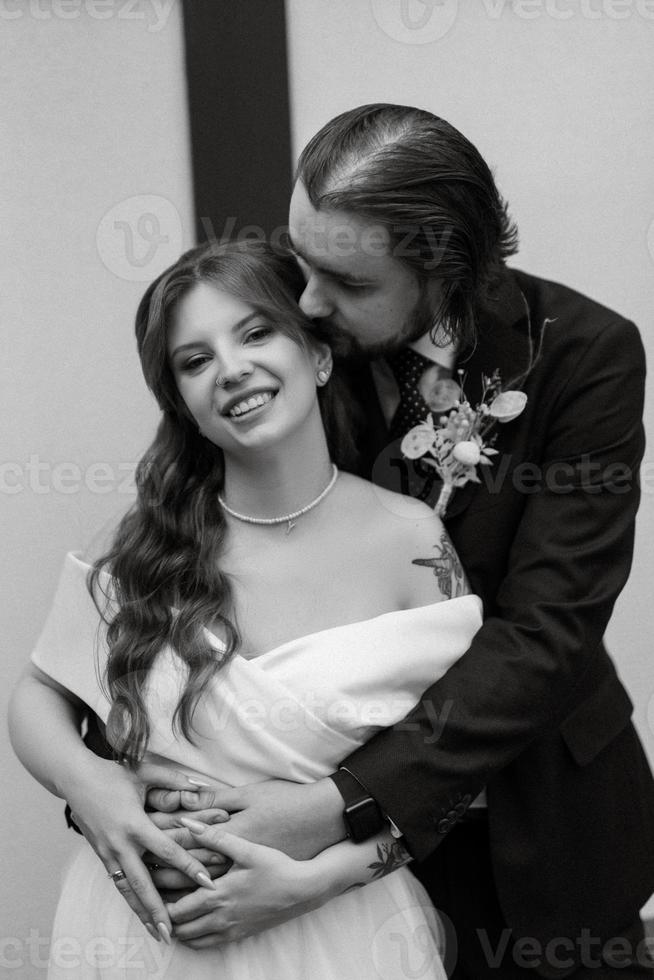young couple bride and groom in a white dress photo