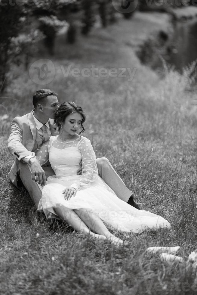 bride in a light wedding dress to the groom in a blue suit photo