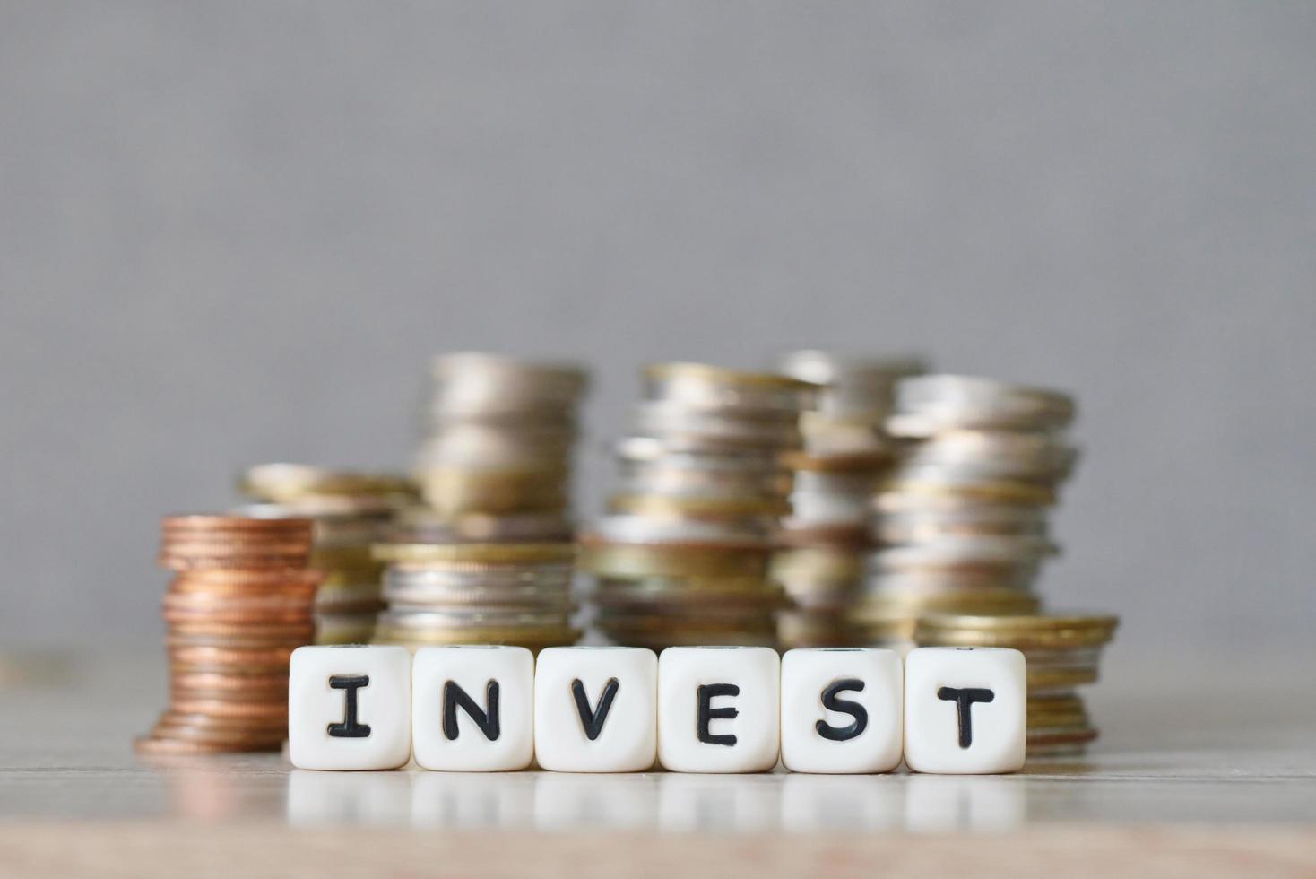 invest and a coin on wooden table background, invest business economy concept of money and finance investments photo