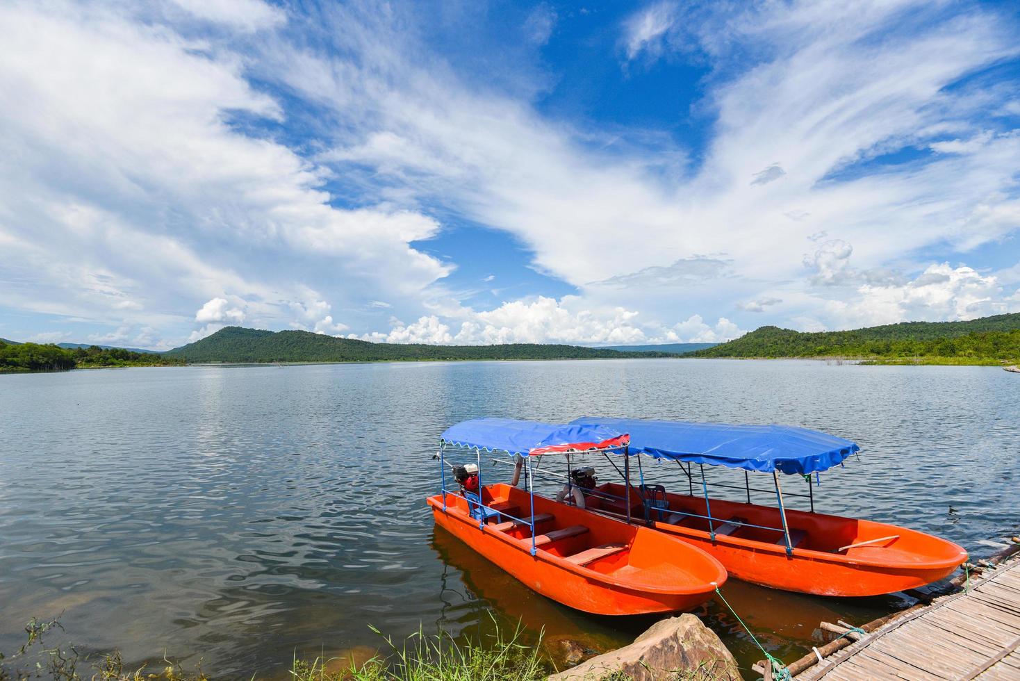 Small fisher boats at the harbour in iver water in thailand blue sky with clouds beautiful and island mountain background landscape - Plastic boat photo