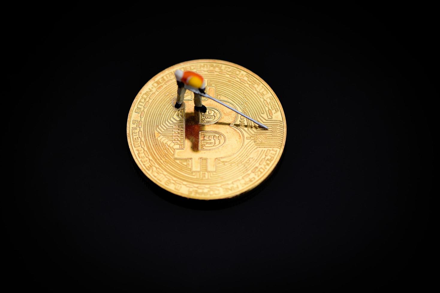 Figurines working Mining Bitcoin Golden digging on virtual cryptocurrency bitcoin mining concept photo