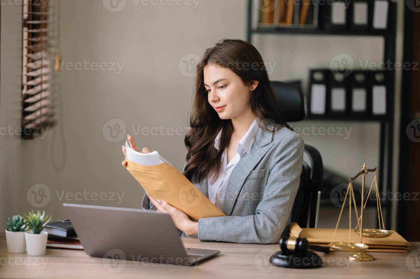 bella abogada asiática trabajando y martillo, tableta, computadora portátil al frente, consejo de justicia y concepto de ley. foto