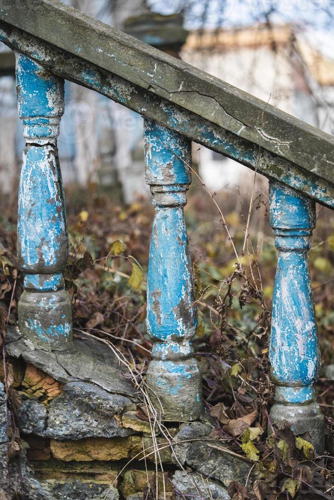 a balustrade on the railing of an old cracked staircase photo