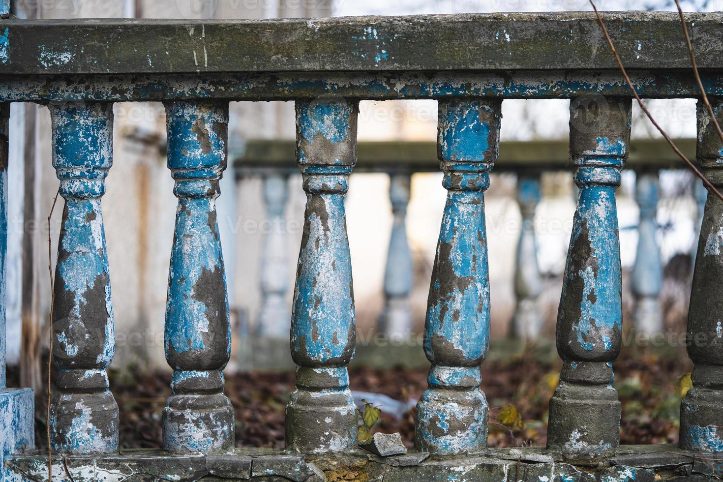 a balustrade on the railing of an old cracked staircase photo