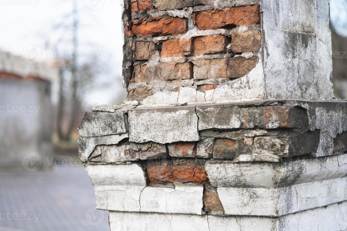 texture of old cracked and destroyed red brick wall photo