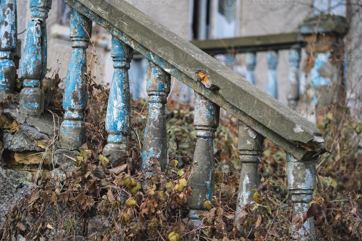 una balaustrada en la baranda de una vieja escalera agrietada foto