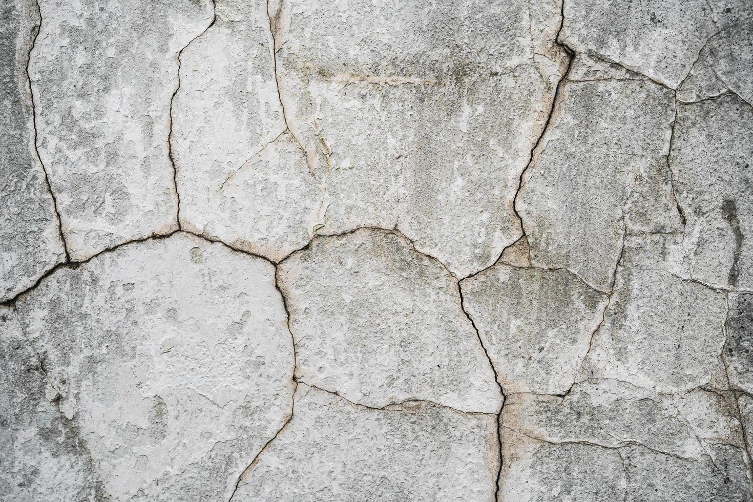 close up texture of cracked plaster on old house wall photo