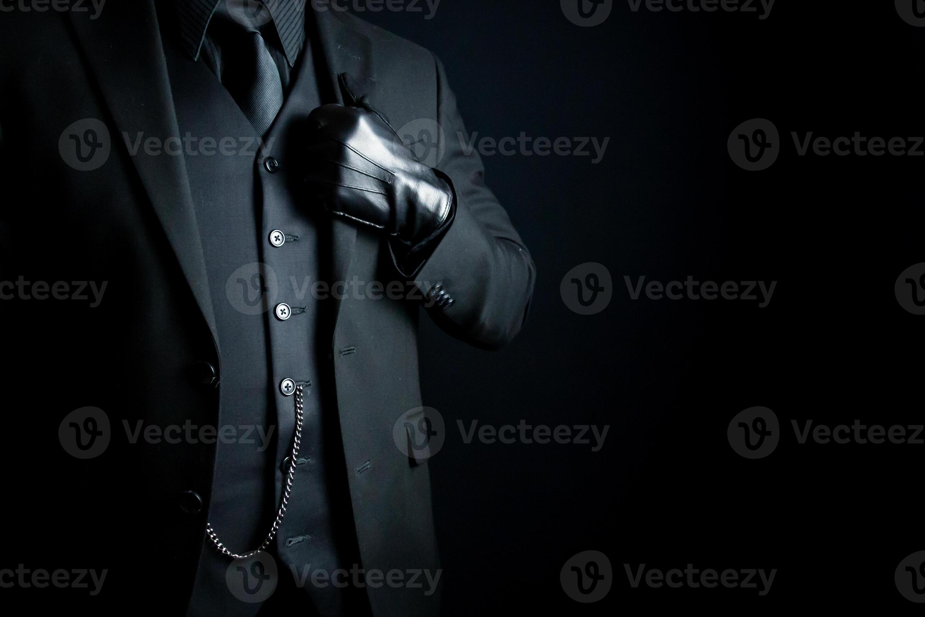 Portrait of Mysterious Man in Dark Suit and Leather Gloves Standing
