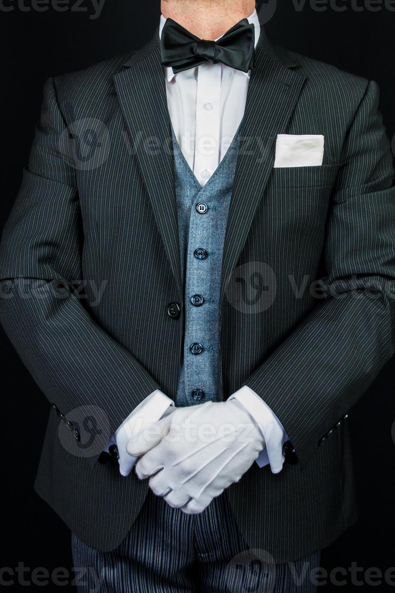 Butler in Formal Suit and White Gloves Standing at Attention. At Your
