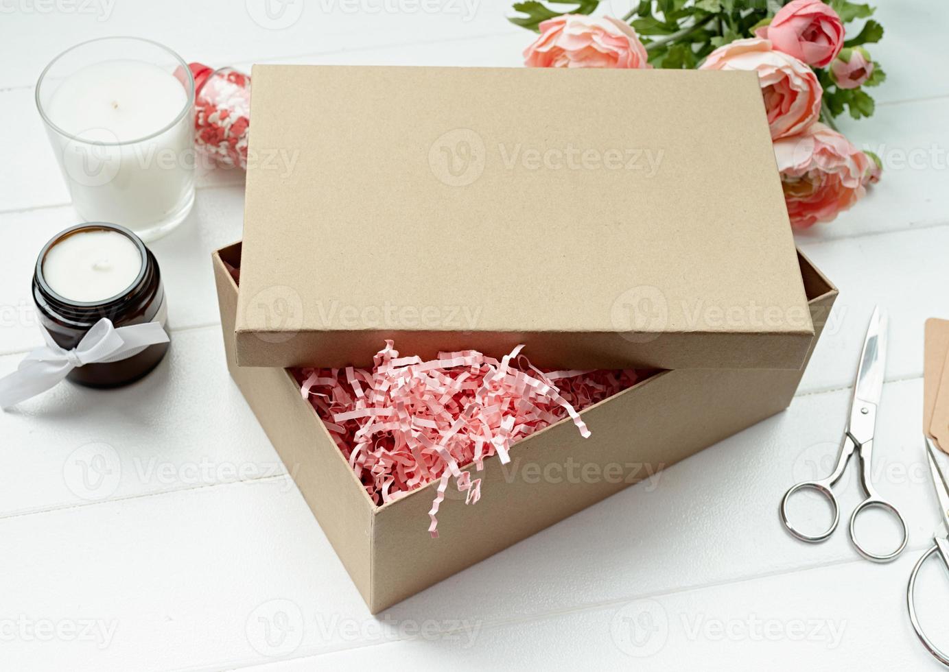 Shredded pink paper packing material texture in a craft box, mockup design photo