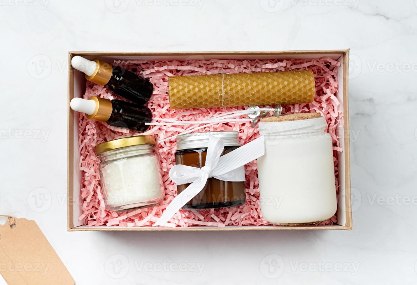 Gift box with candle making tools, candle, soy wax, wicks and aroma oil bottles photo