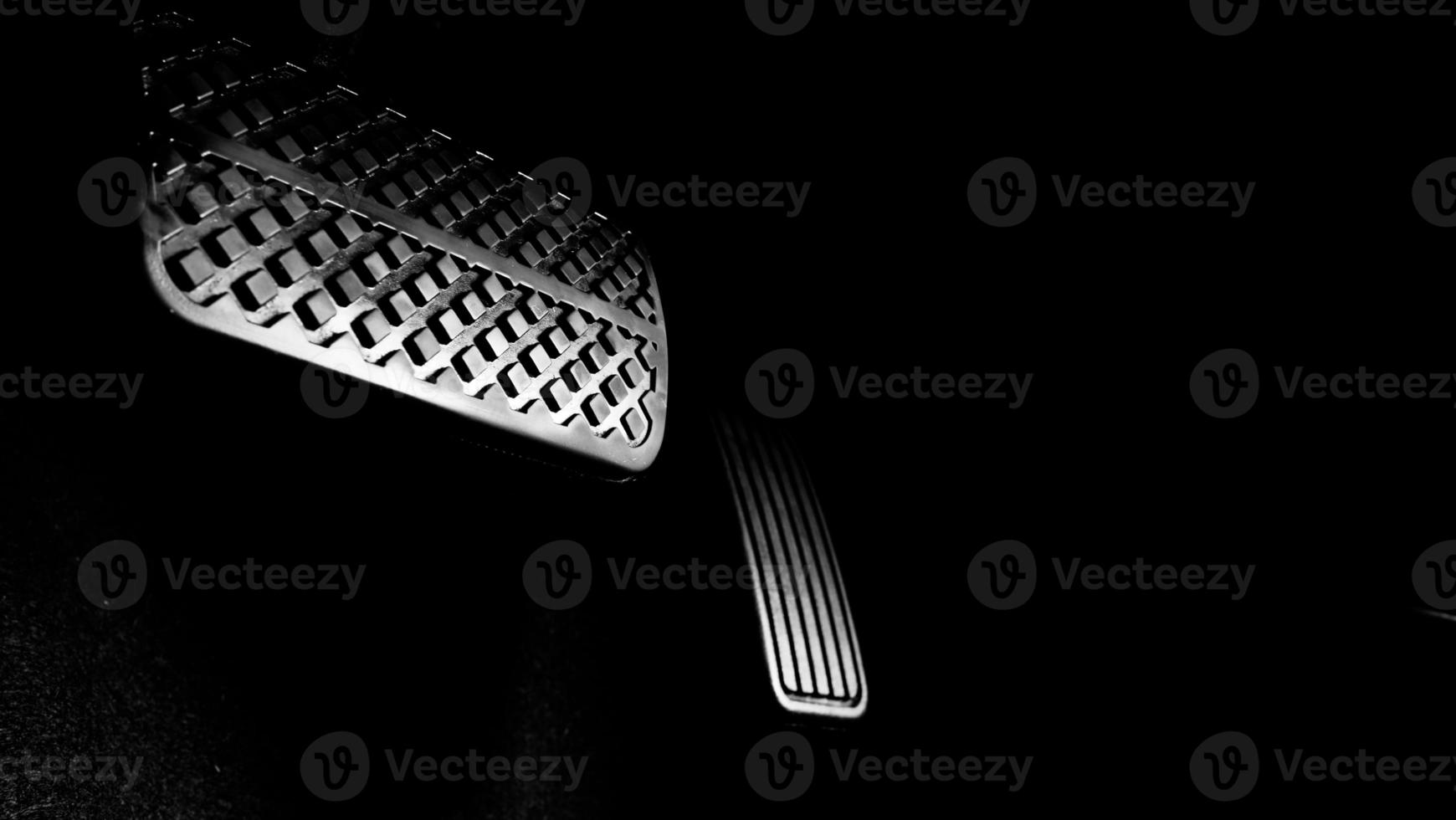 Close up foot press or push foot break and accelerate pedal of a car to drive ahead. photo