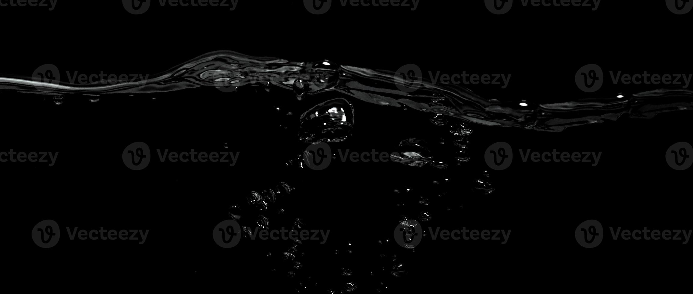 Liquid suface line between underwater and above water with black background. photo