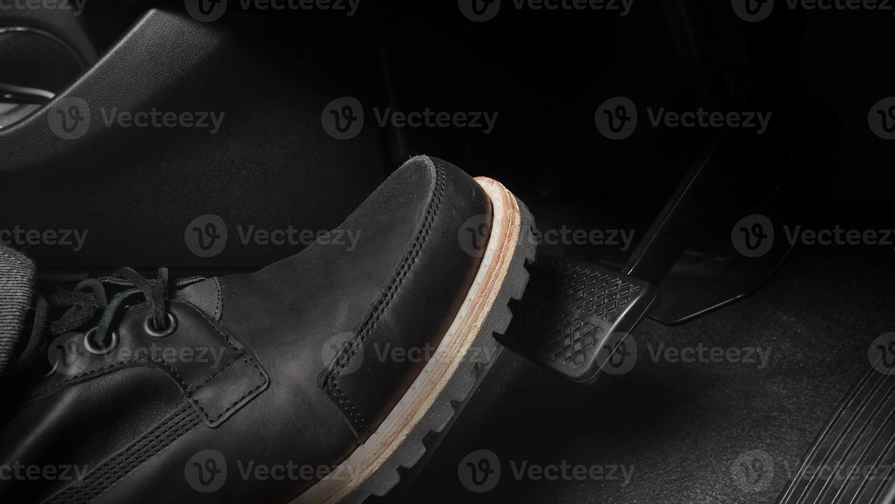 Close up foot press or push foot break and accelerate pedal of a car to drive ahead. photo