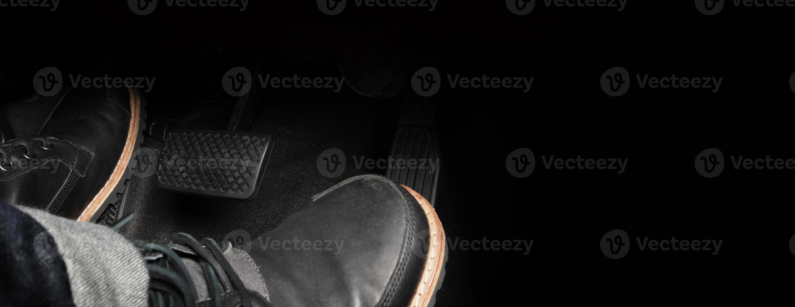 Close up foot press or push foot break and accelerate pedal of a car to drive ahead. photo