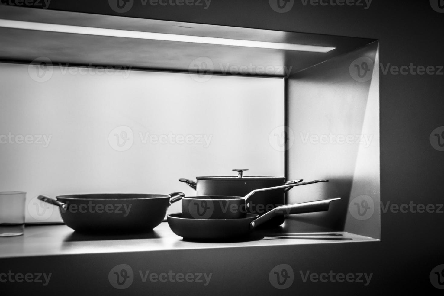 A minimalistic still life with pots and pans in black and white photo