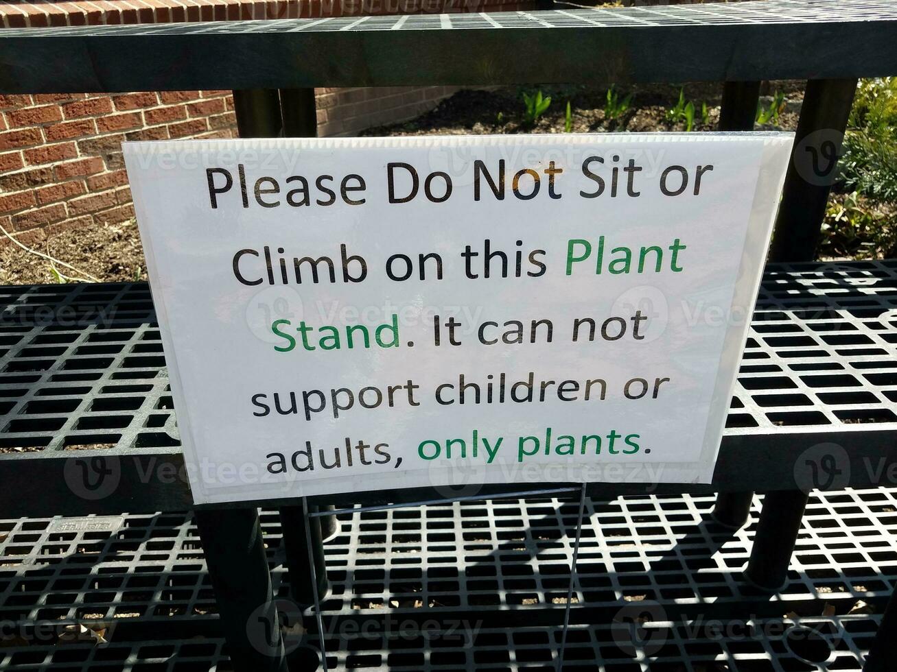 please do not sit or climb plant stand sign photo