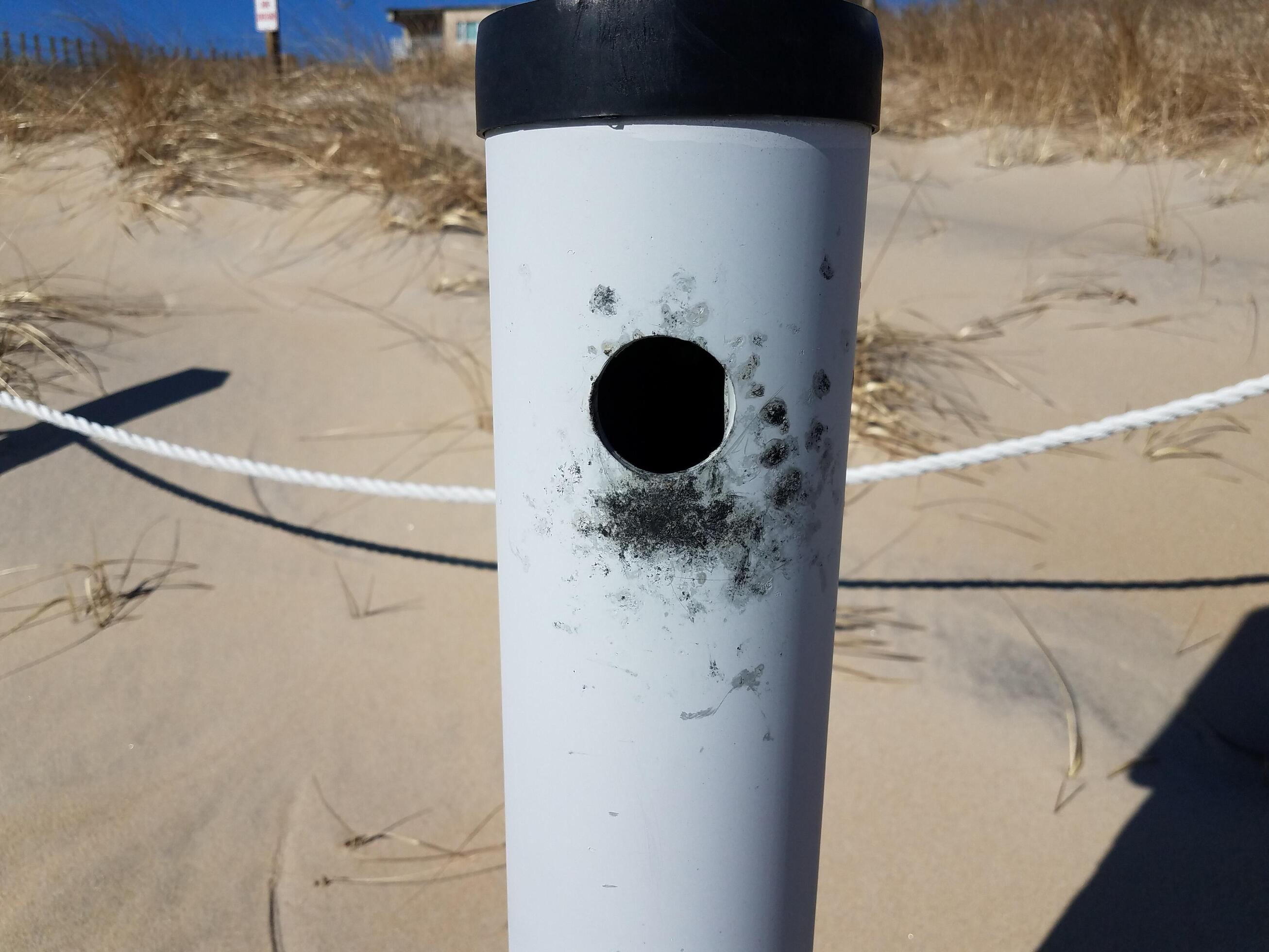 metallic cigarette smoking trash can at beach with sand 17729169 Stock