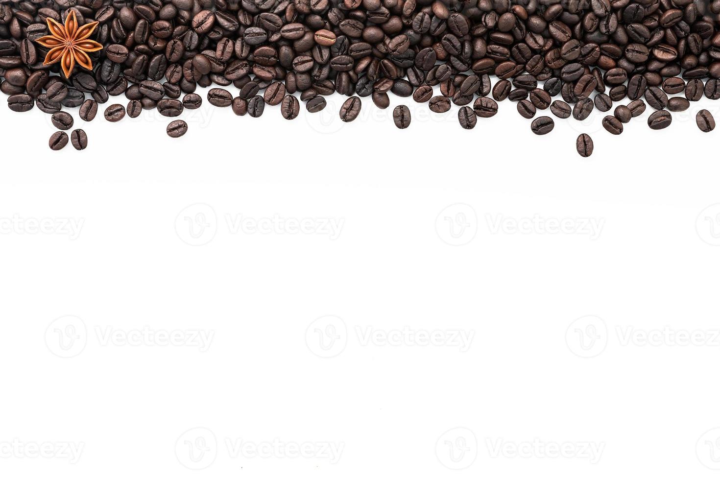 Dark roasted coffee beans setup on white background with copy space. photo