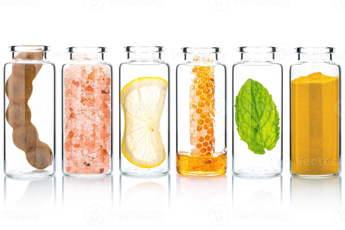 The glass bottle of homemade skin care and body scrubs with natural ingredients aloe vera ,himalayan salt ,peppermint ,rosemary ,turmeric and honey isolate on white background. photo