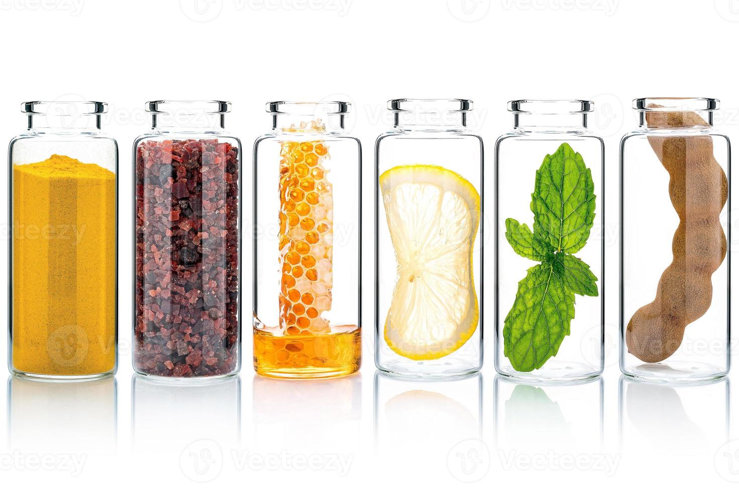 The glass bottle of homemade skin care and body scrubs with natural ingredients aloe vera ,himalayan salt ,peppermint ,rosemary ,turmeric and honey isolate on white background. photo