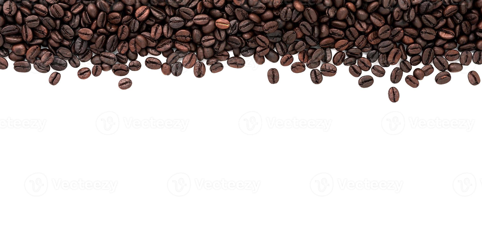 Dark roasted coffee beans setup on white background with copy space. photo