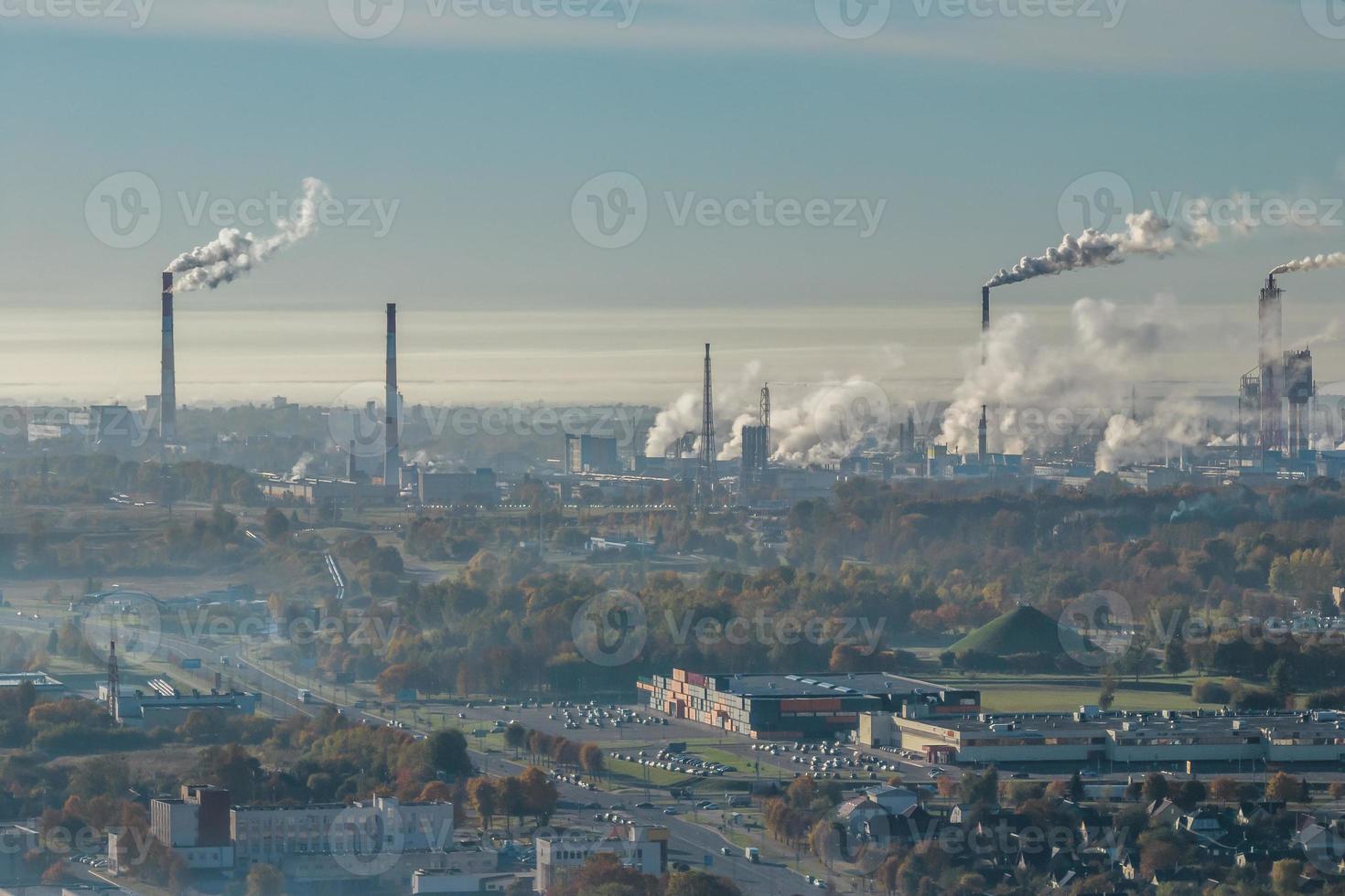 panoramic aerial view of the smoke of pipes as background of huge residential complex with high-rise buildings and private sector . Air and water pollution concept photo