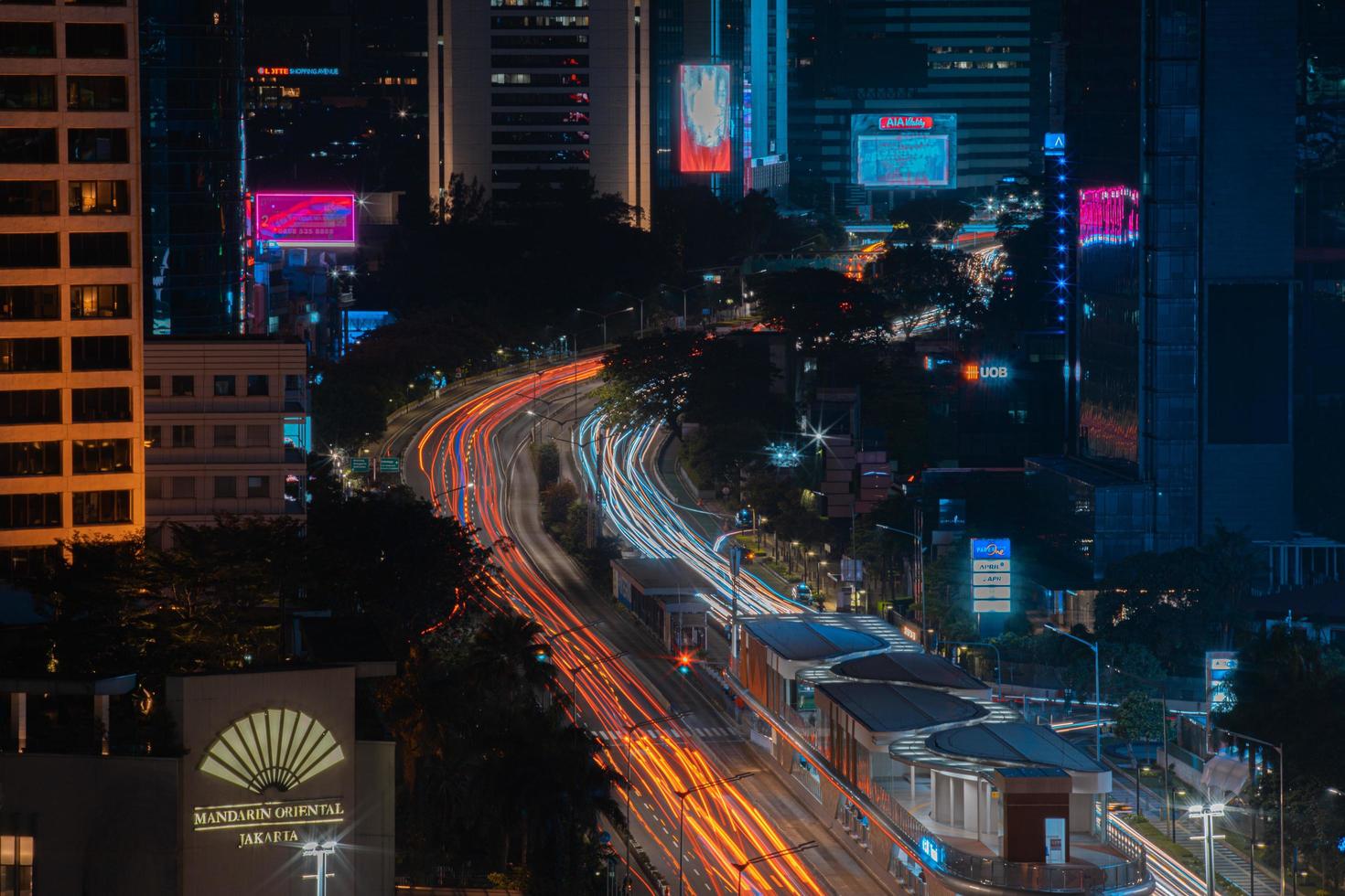 Night cityscape,and traffic light of highway in slow speed shutter motion effect and noise.Jakarta, Indonesia .January 9 2023 photo