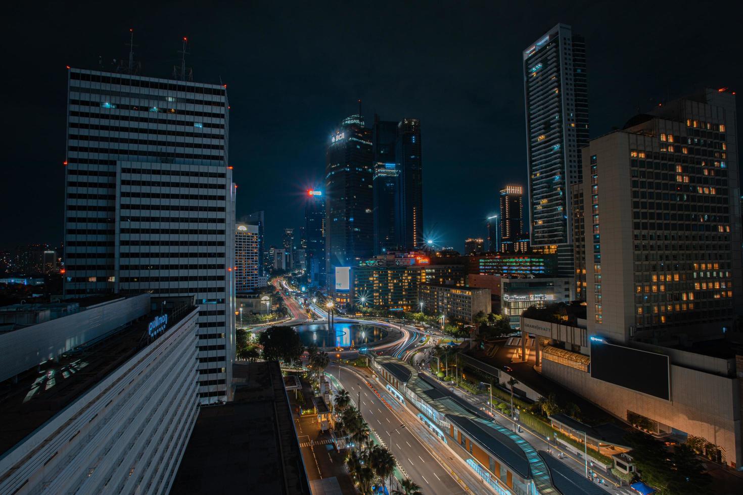 Night cityscape,and traffic light of highway in slow speed shutter motion effect and noise.Jakarta, Indonesia .January 9 2023 photo