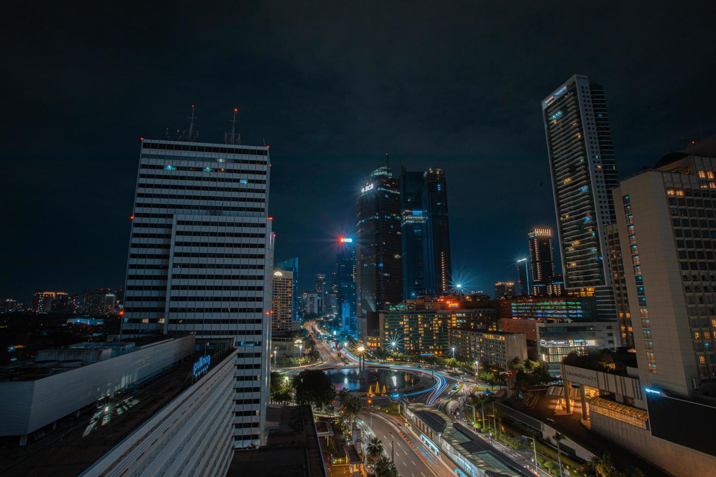 Night cityscape,and traffic light of highway in slow speed shutter motion effect and noise.Jakarta, Indonesia .January 9 2023 photo