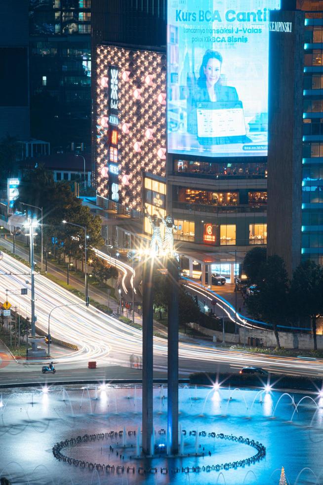 Night cityscape,and traffic light of highway in slow speed shutter motion effect and noise.Jakarta, Indonesia .January 9 2023 photo