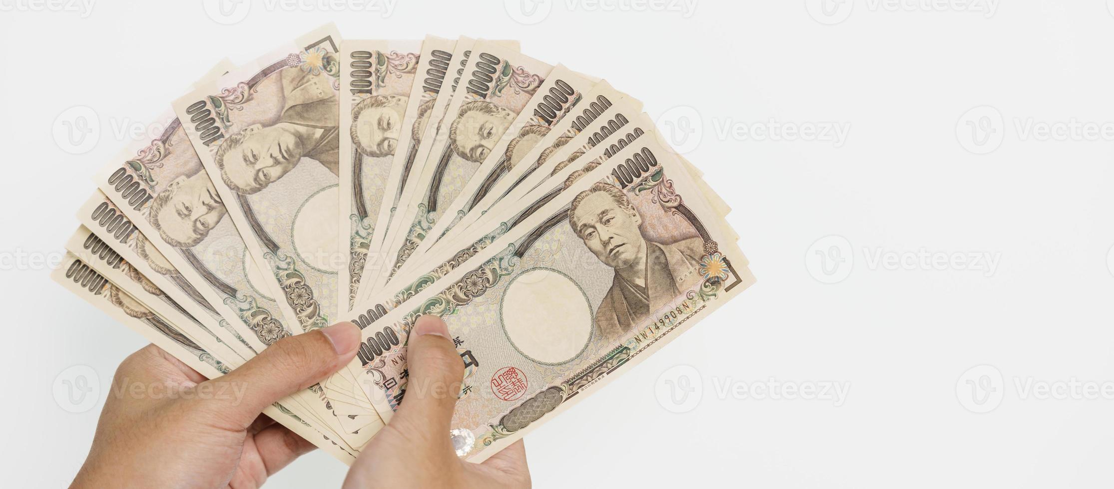 man hand holding Japanese Yen banknote stack. Thousand Yen money. Japan cash, Tax, Recession Economy, Inflation, Investment, finance and shopping payment concepts photo