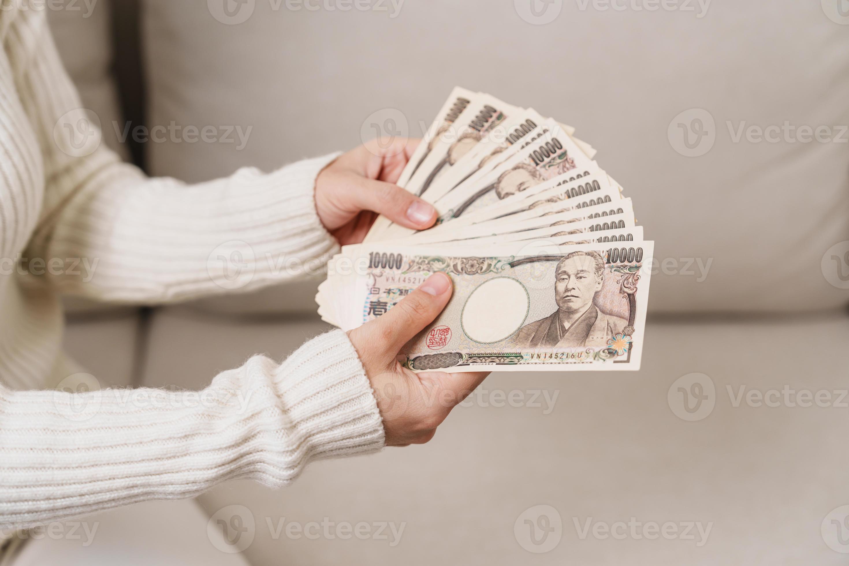 Woman hand holding Japanese Yen banknote stack. Thousand Yen money. Japan  cash, Tax, Recession Economy, Inflation, Investment, finance and shopping  payment concepts 17732733 Stock Photo at Vecteezy