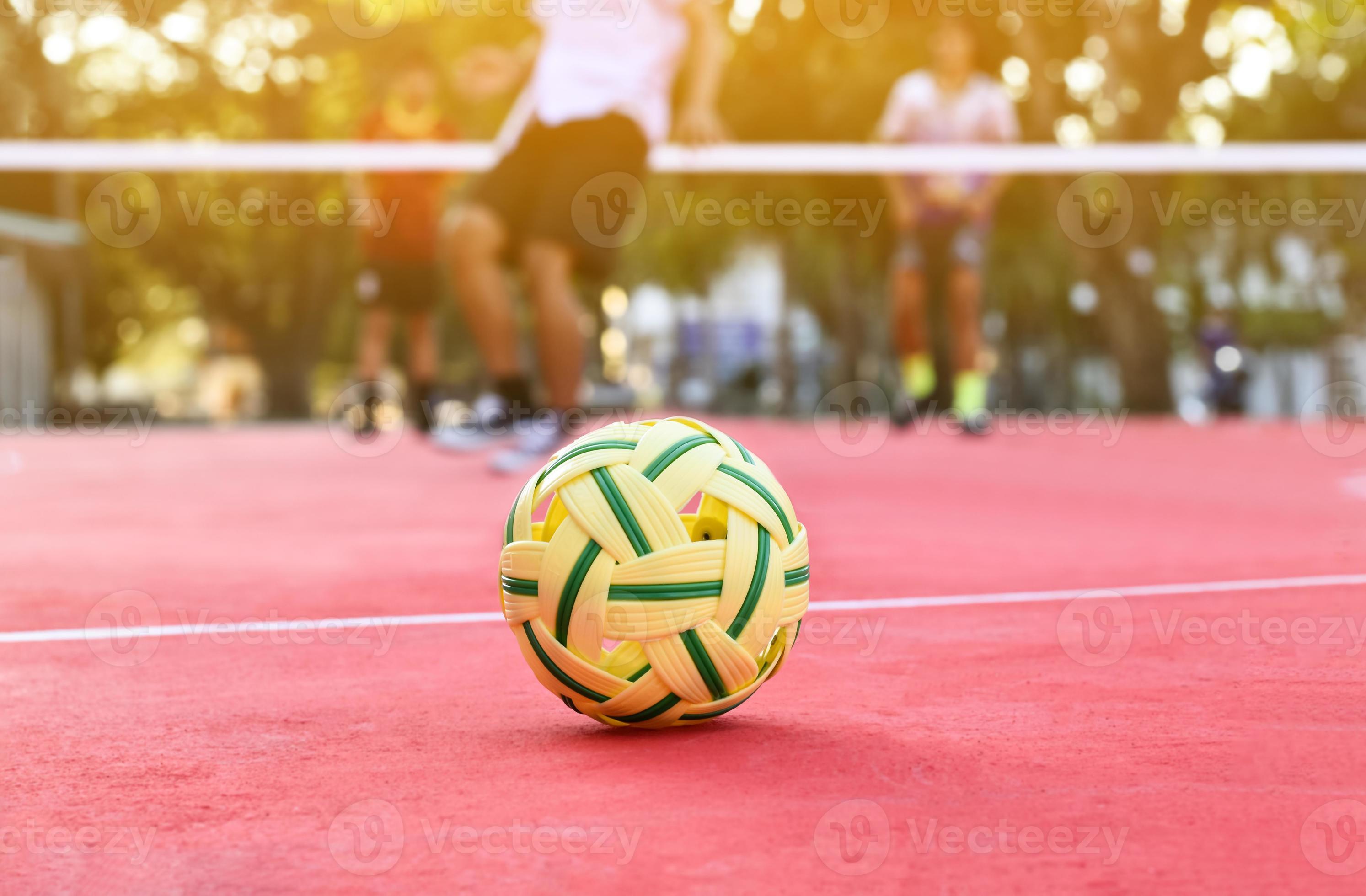 Sepak Takraw Ball On Red Floor Of Outdoor Court Blurred Background Recreactional Activity And Outdoor Sports In Southeast Asian Countries Concept Photo 