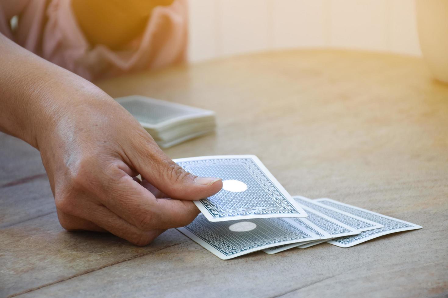 Card playing of elderly people at home in their freetimes, recreation and happiness of elderly people concept. photo