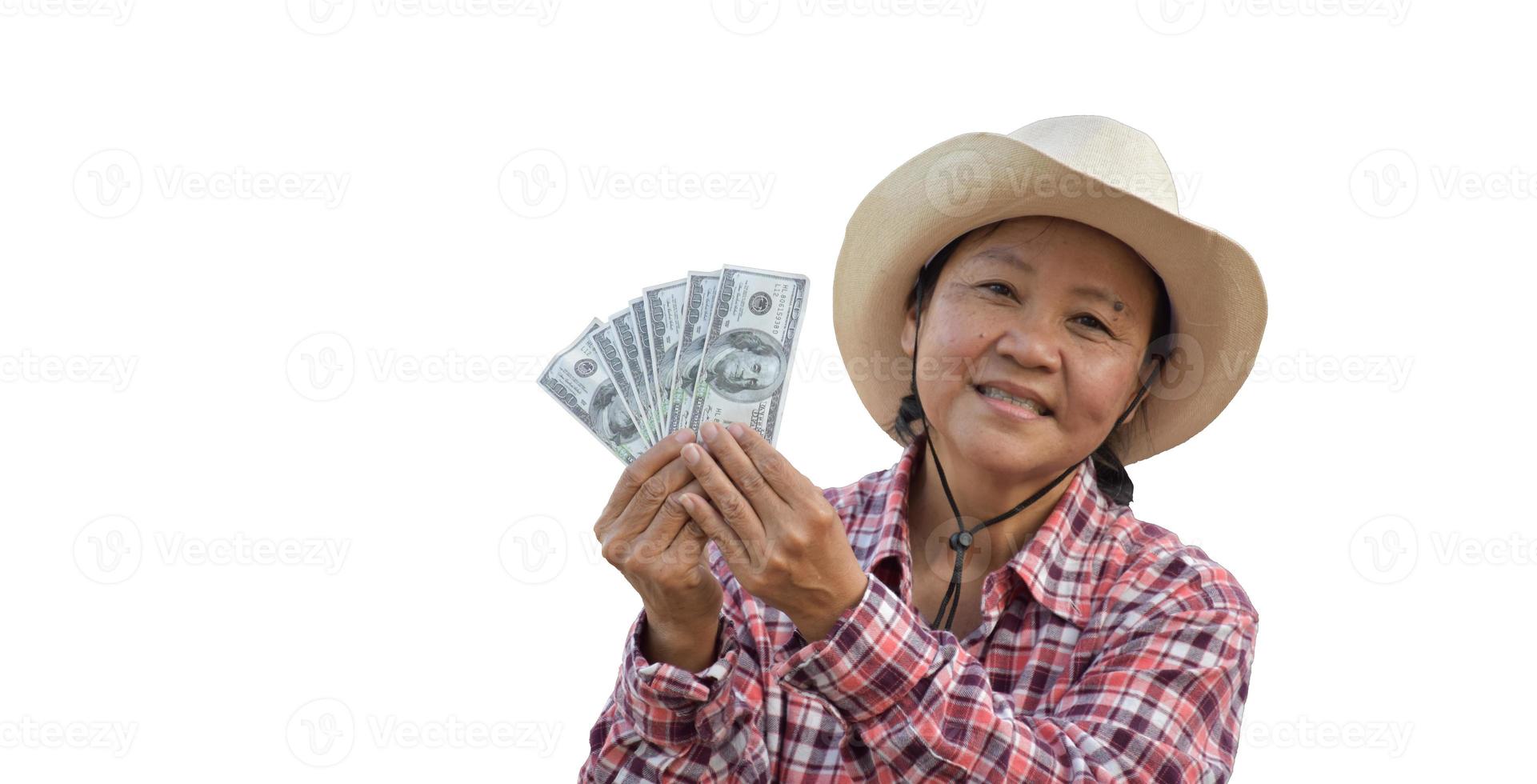 Isolated elderly asian woman holds US dollar bank notes in hand with beautiful smiling on her face happily with clipping paths. photo