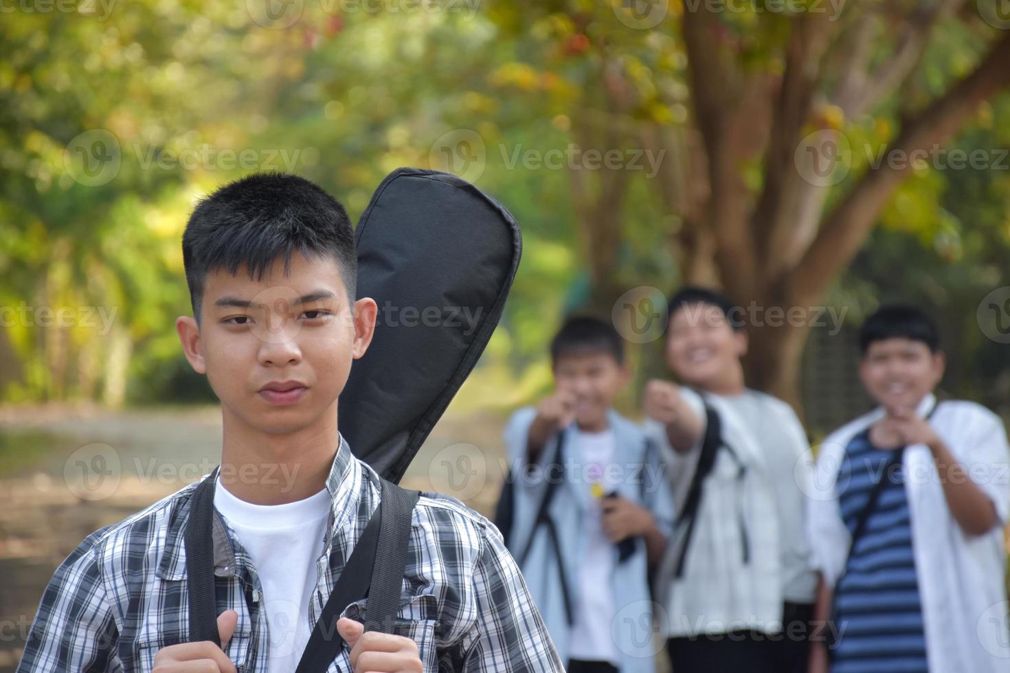 Portrait young asian teens spending freetime together along the way walking to home after music lesson at school, young adult asian couple concept. photo