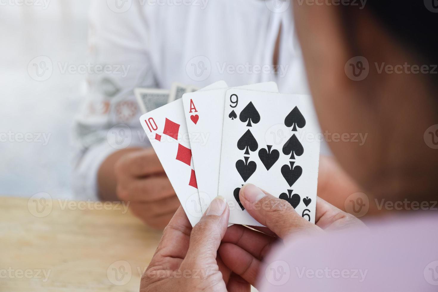 Card playing of elderly people at home in their freetimes, recreation and happiness of elderly people concept. photo
