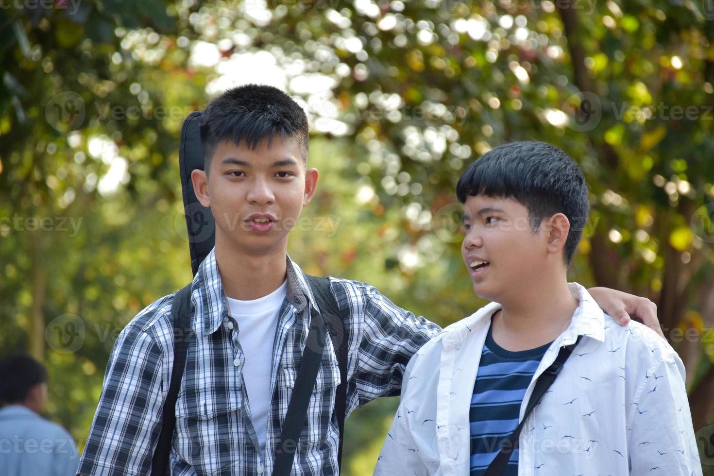 Portrait young asian teens spending freetime together along the way walking to home after music lesson at school, young adult asian couple concept. photo