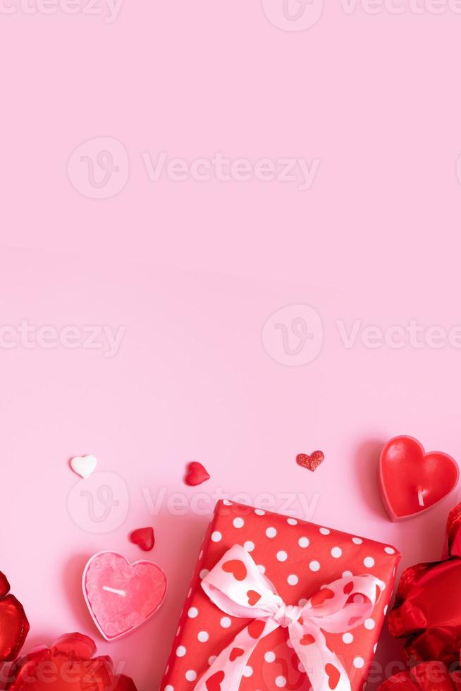 Gift box, candels and red heart shape baloons on pink background. Valentines Day concept photo